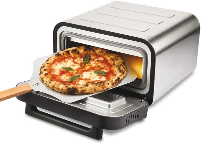 Compact high-temperature pizza oven with a pizza on the peel